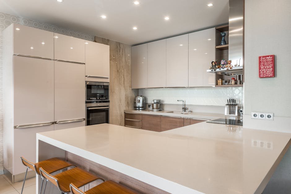 Contemporary kitchen featuring sleek cabinets, countertops, and modern appliances.