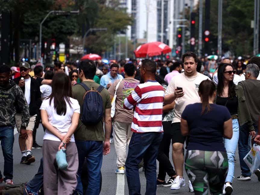 A bustling city street filled with diverse people during the day.
